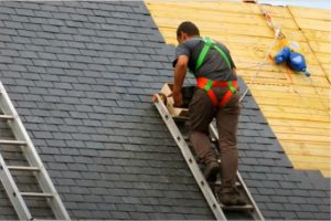 Worker replacing to a new shingled roof